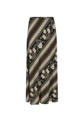  walking outdoors on a gravel path surrounded by white flowers and greenery.